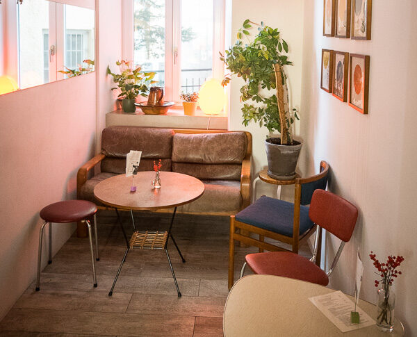 Ein rosaner Raum eines Cafes mit gemütlichem Ambiente.